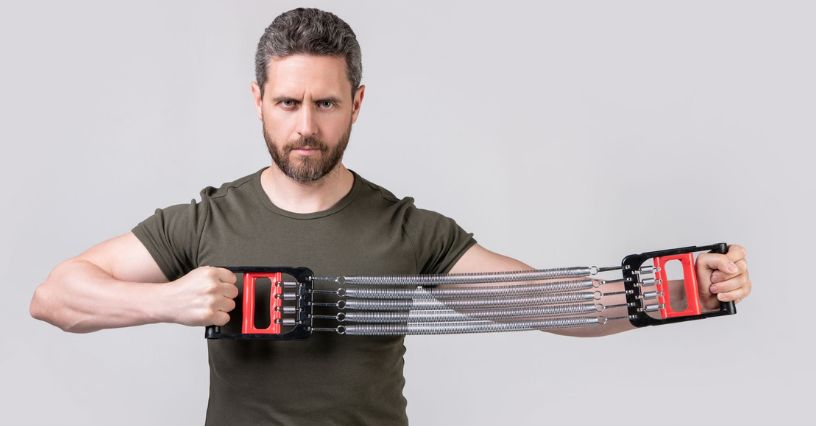 Bărbat demonstrează cum se folosește un extensor pentru exerciții