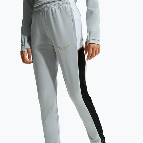 Pantaloni pentru copii Nike Academy Dri-Fit Jr light smoke grey/white/black/metallic gold