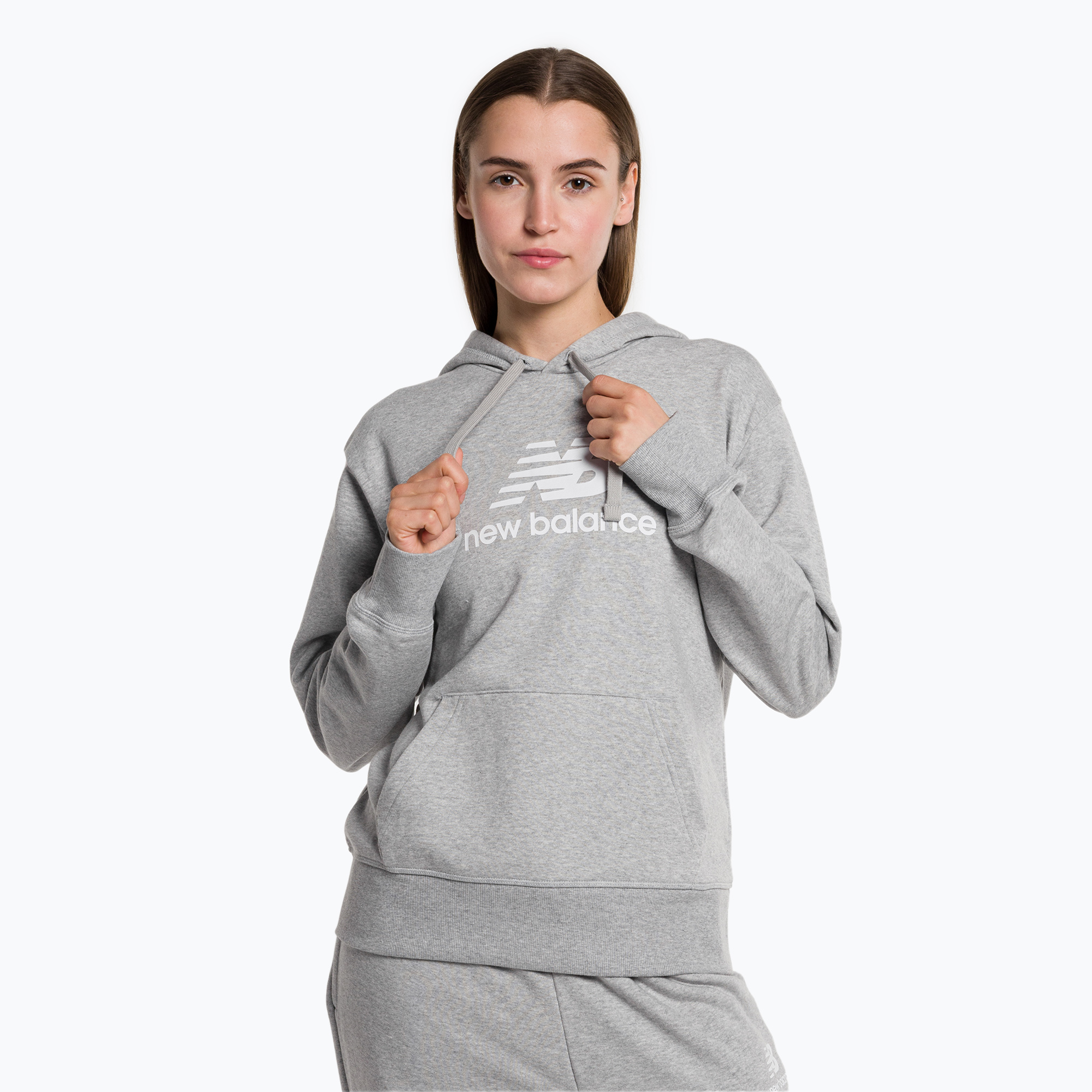 Tricou de antrenament pentru femei New Balance Essentials Essentials Stacked Logo French Terry Hoodie gri NBWT31533 (Essentials Stacked Logo French Terry Hoodie WT31533AG)